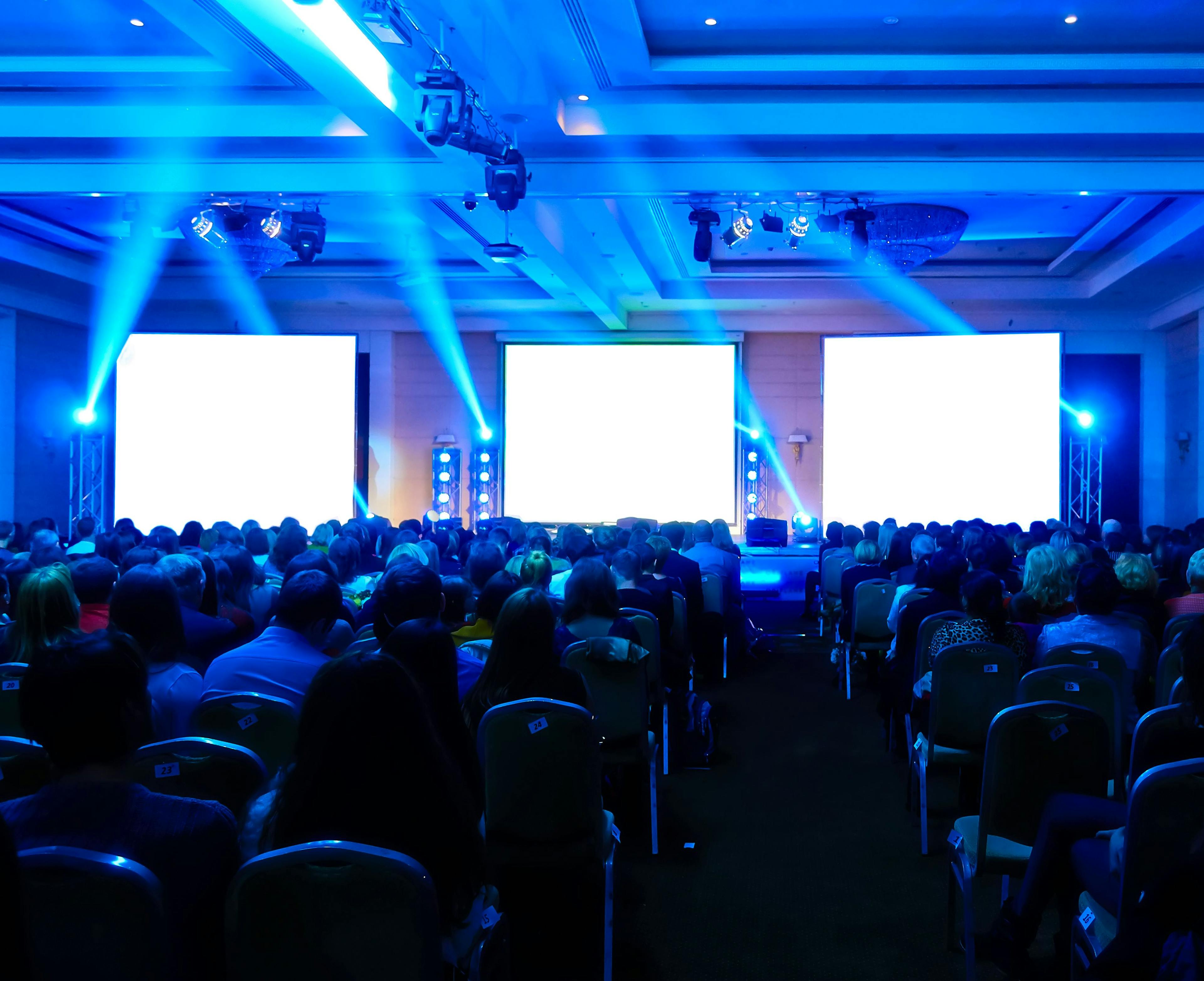 Conference hall facing stage with blue lights