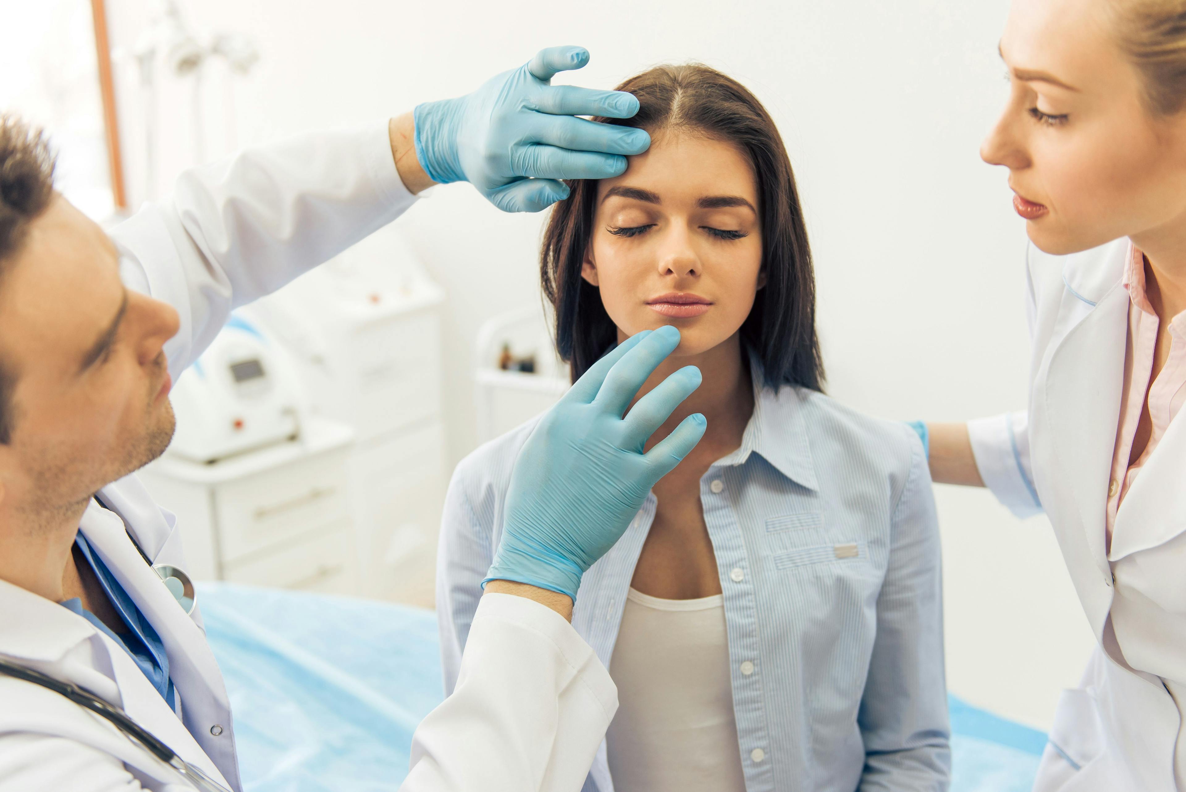 doctors examining a patient's face