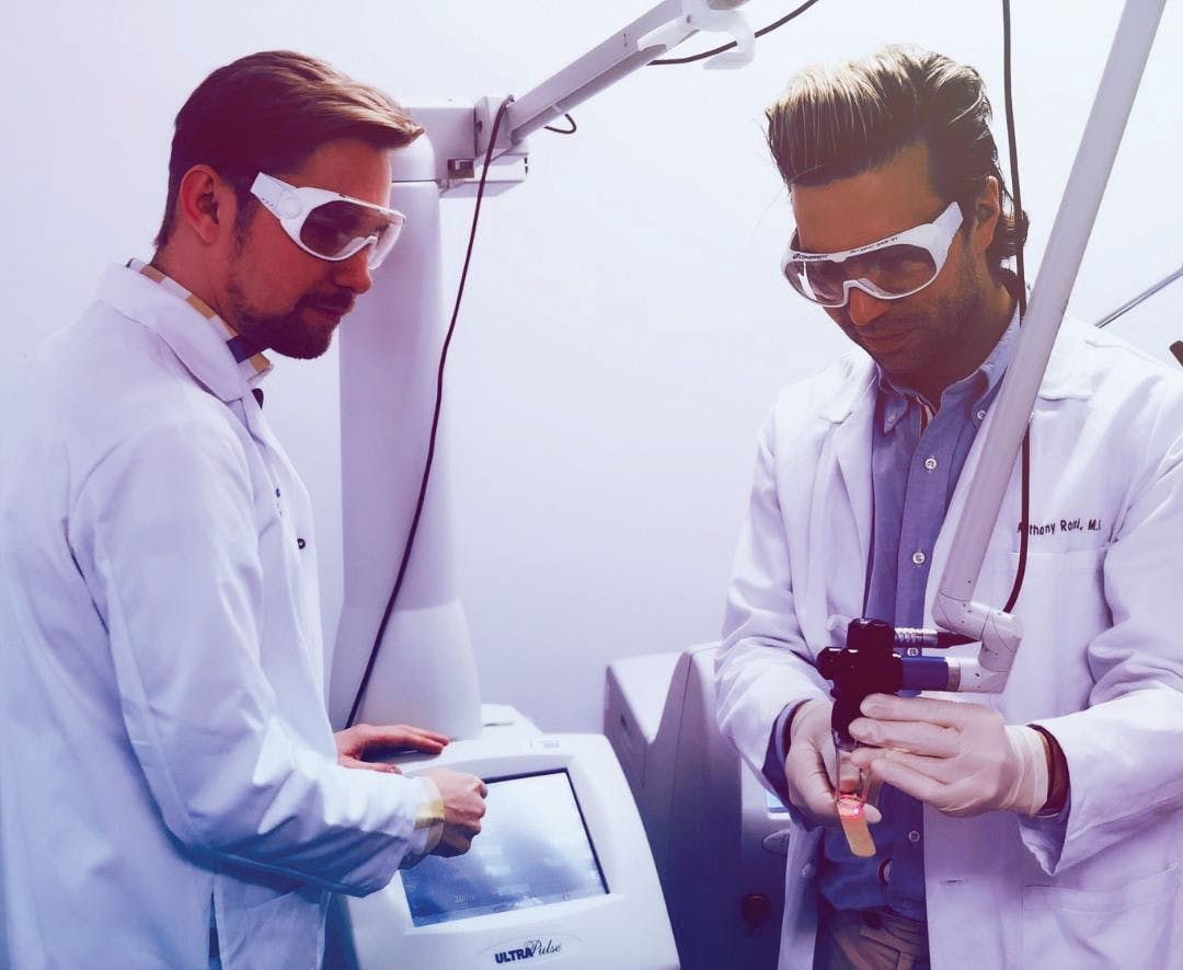 Doctors calibrating a CO2 laser before a procedure