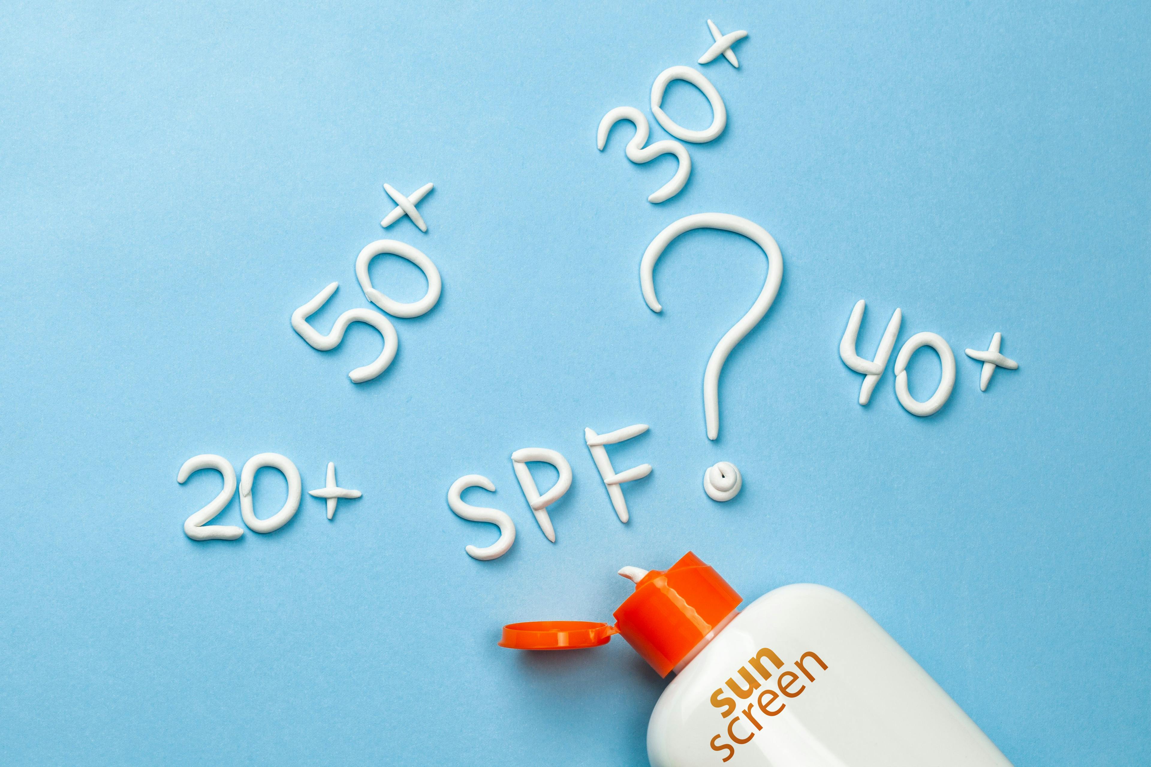 sunscreen bottle. Numbers written in sunscreen: 20+, 50+, 30+, 40+. SPF written in sunscreen.