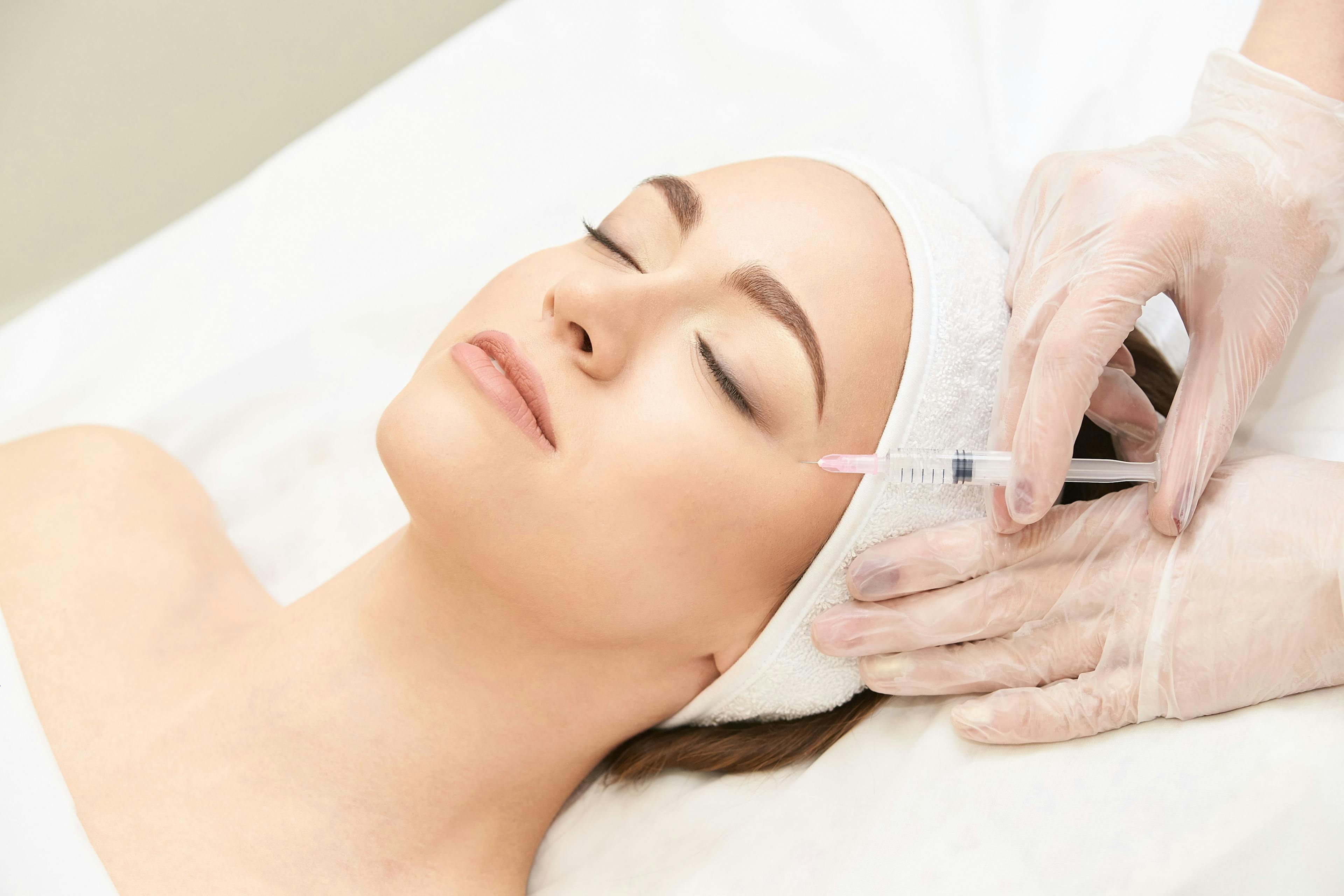 woman being receiving aesthetic injection  