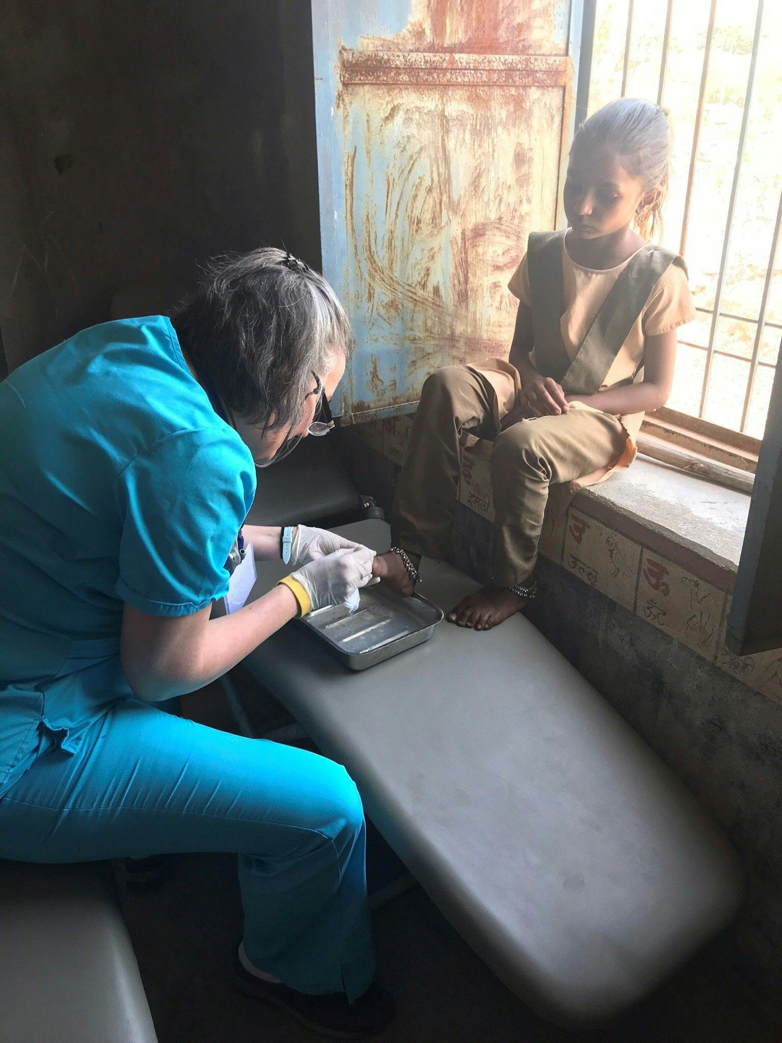 Medical professional treating a pediatric patient